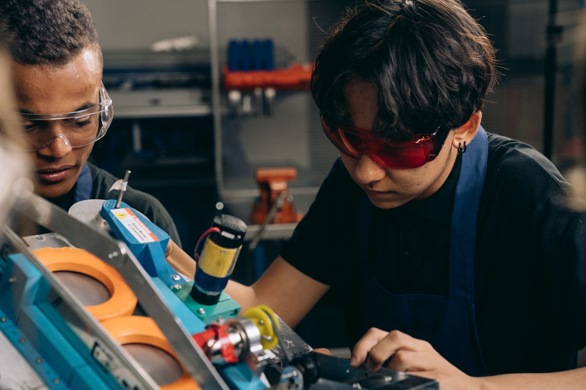 Apprentice getting hands-on training on manufacturing equipment