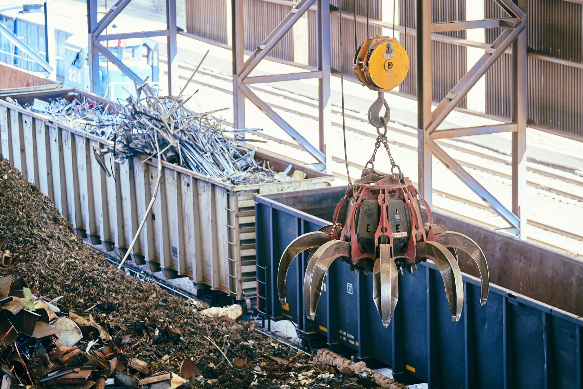 Worker sorting scrap material for reuse at a manufacturing facility
