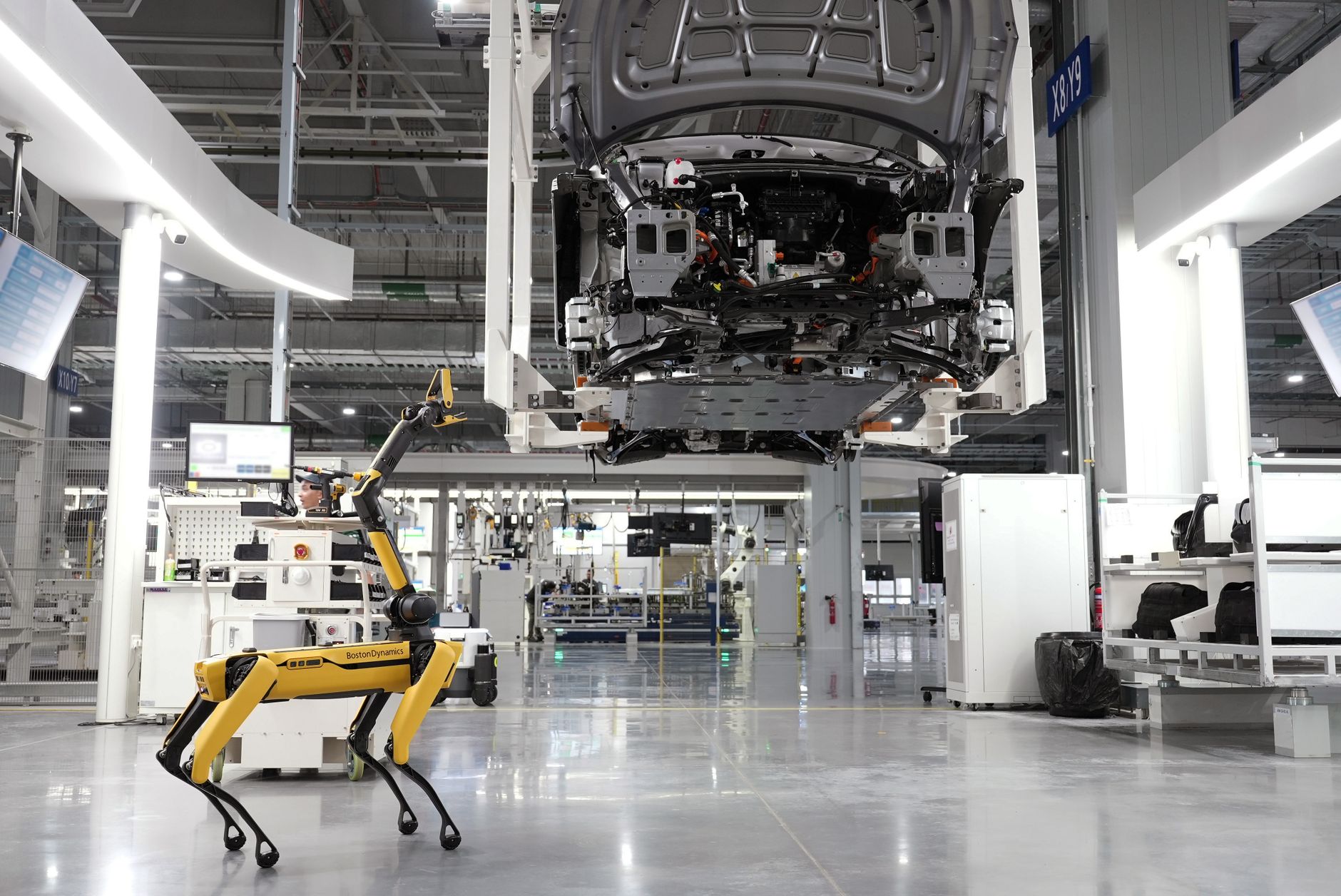 Engineer conducting a risk assessment near a robotic cell