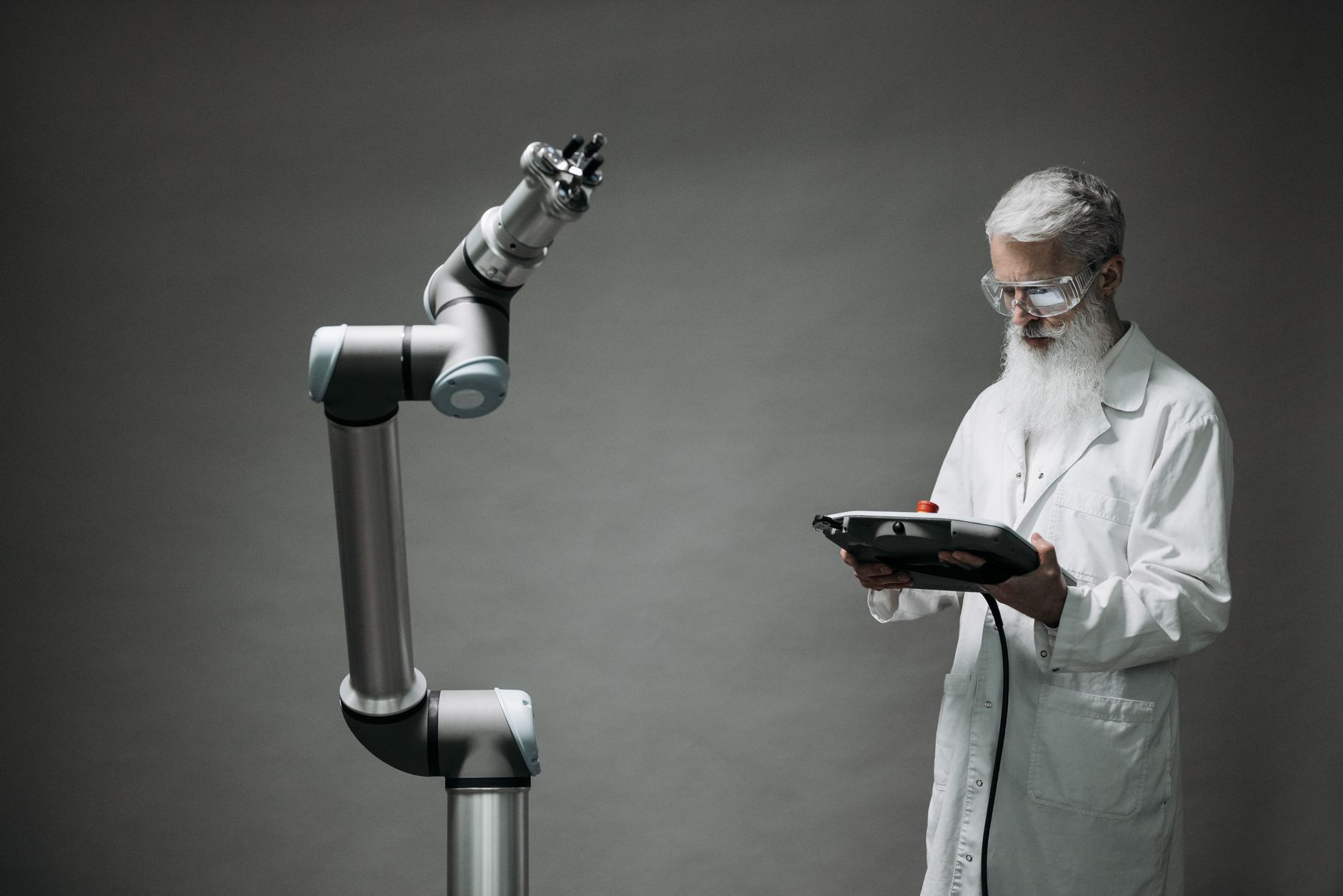 Worker programming a collaborative robot on the shop floor