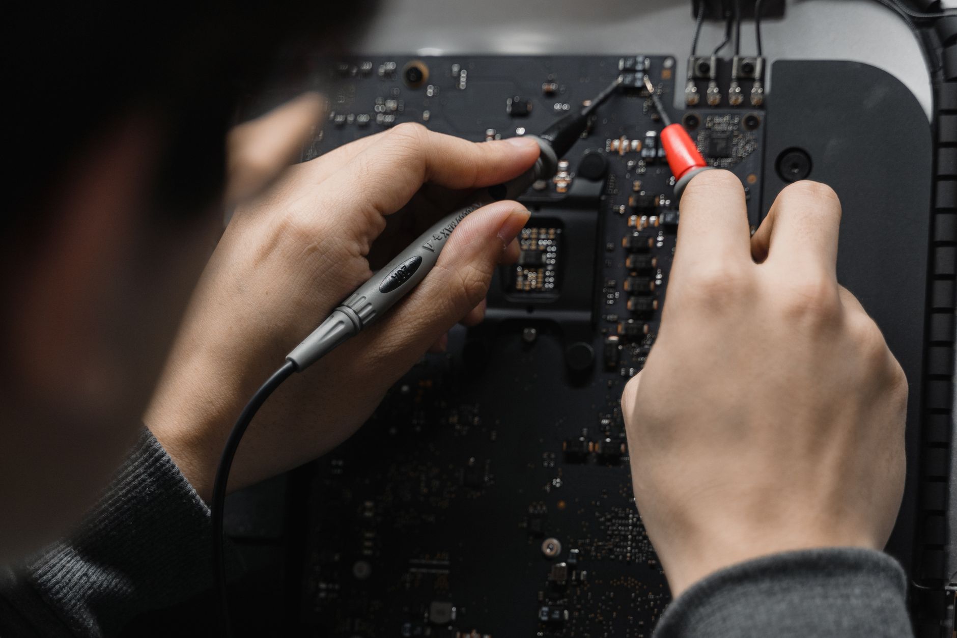 Technician inspecting electronic components on an assembly line