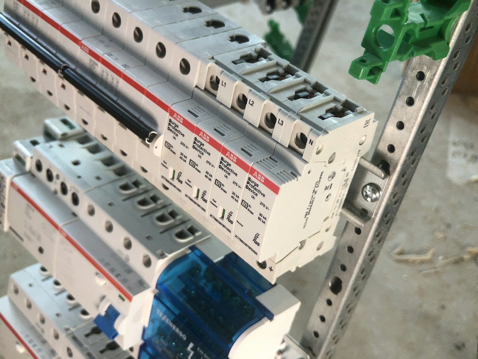 Close-up of DIN-rail mounted electrical protection devices inside an industrial control panel