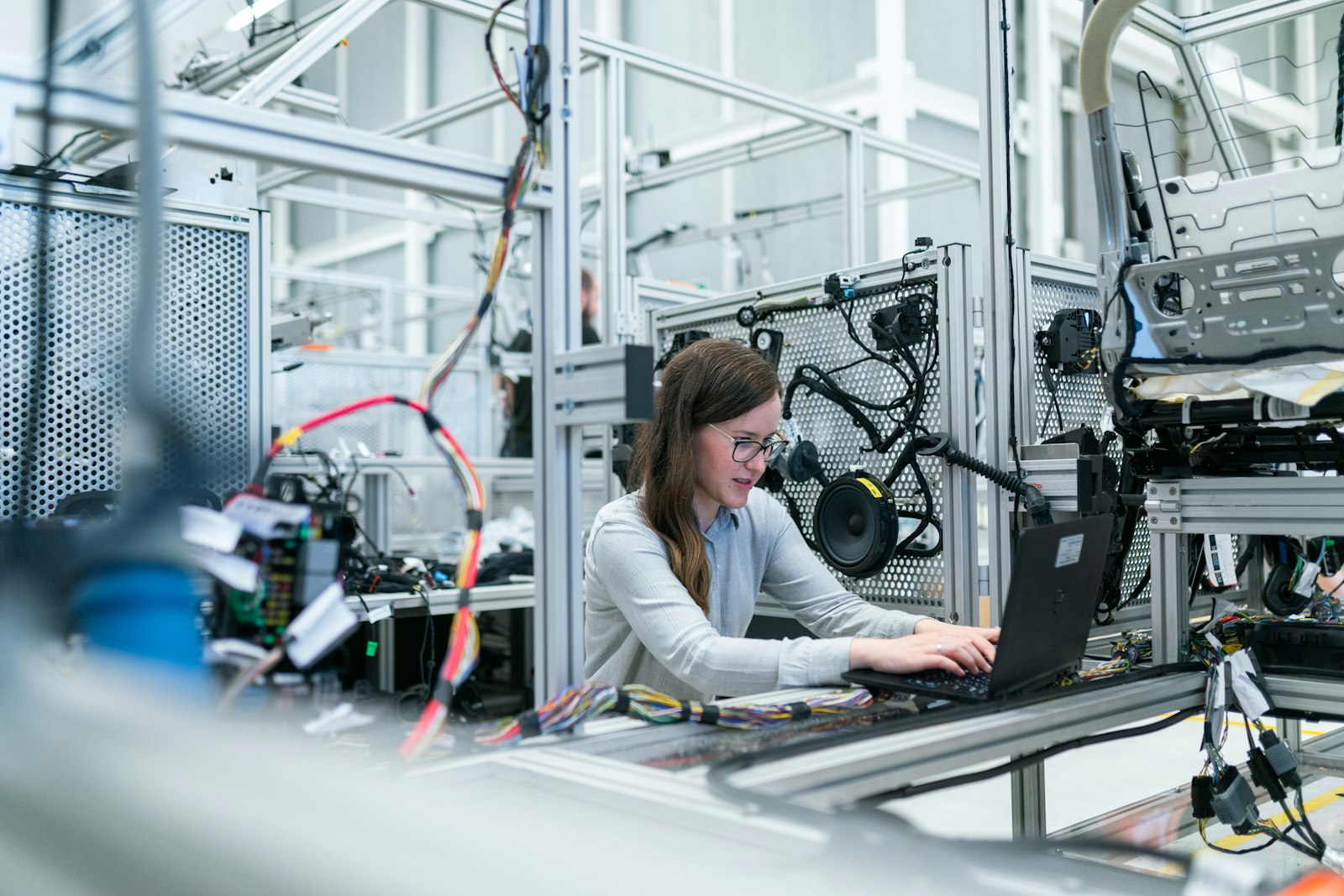 Engineer testing wiring on an industrial rig using a laptop