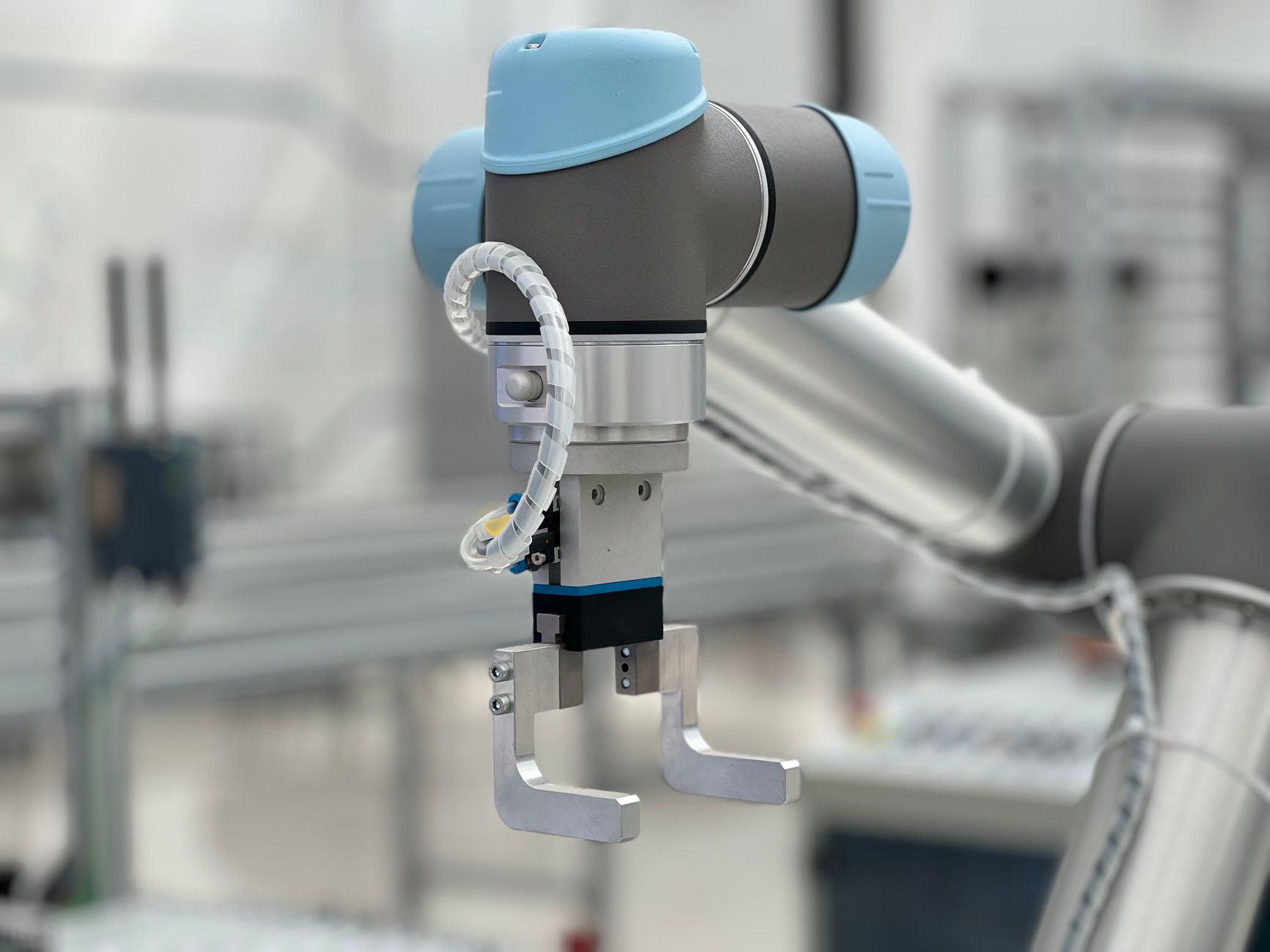 Close-up of robot gripper fingers holding a component