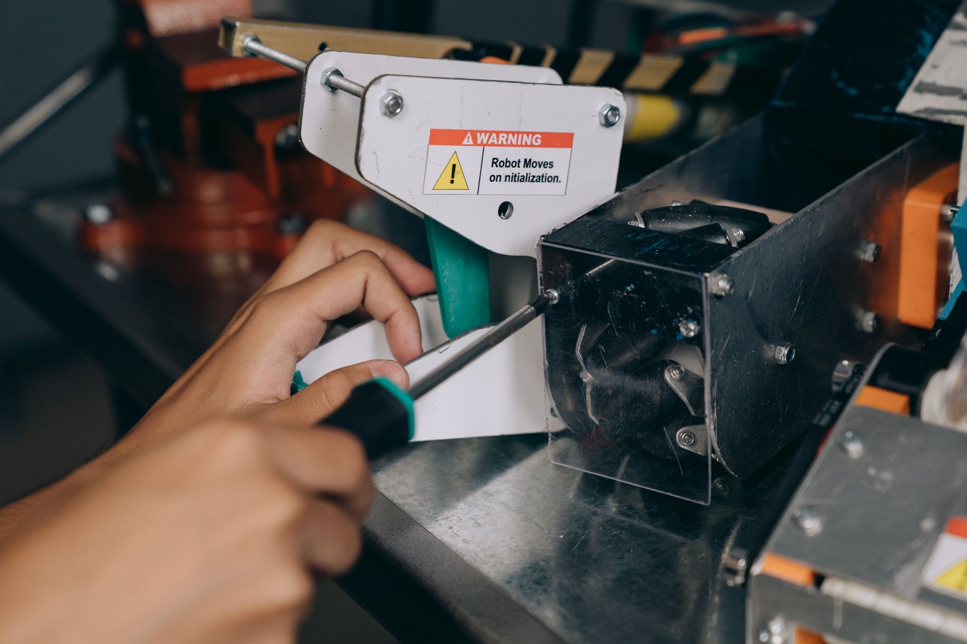 Technician installing a quick-change tool changer on a robot