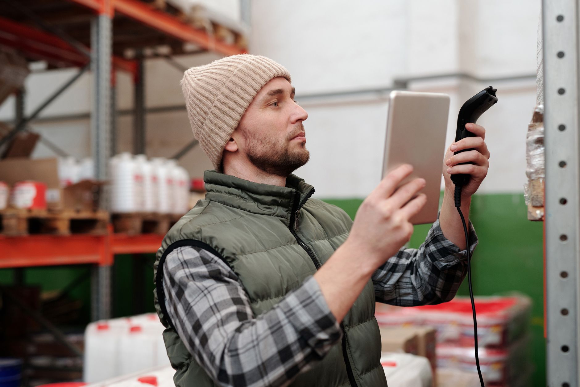 Warehouse manager checking inventory levels on a tablet