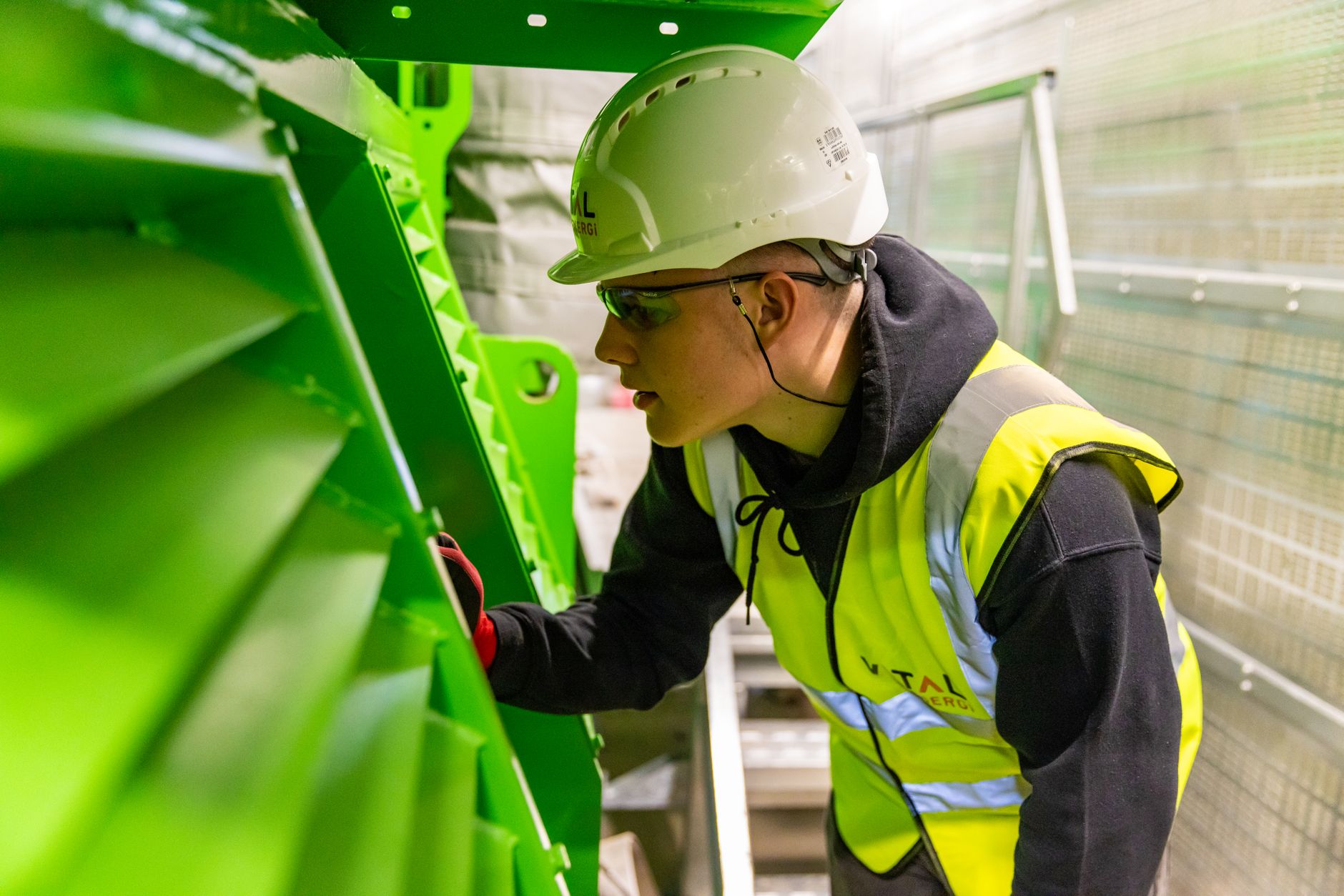 Technician inspecting a guardrail system