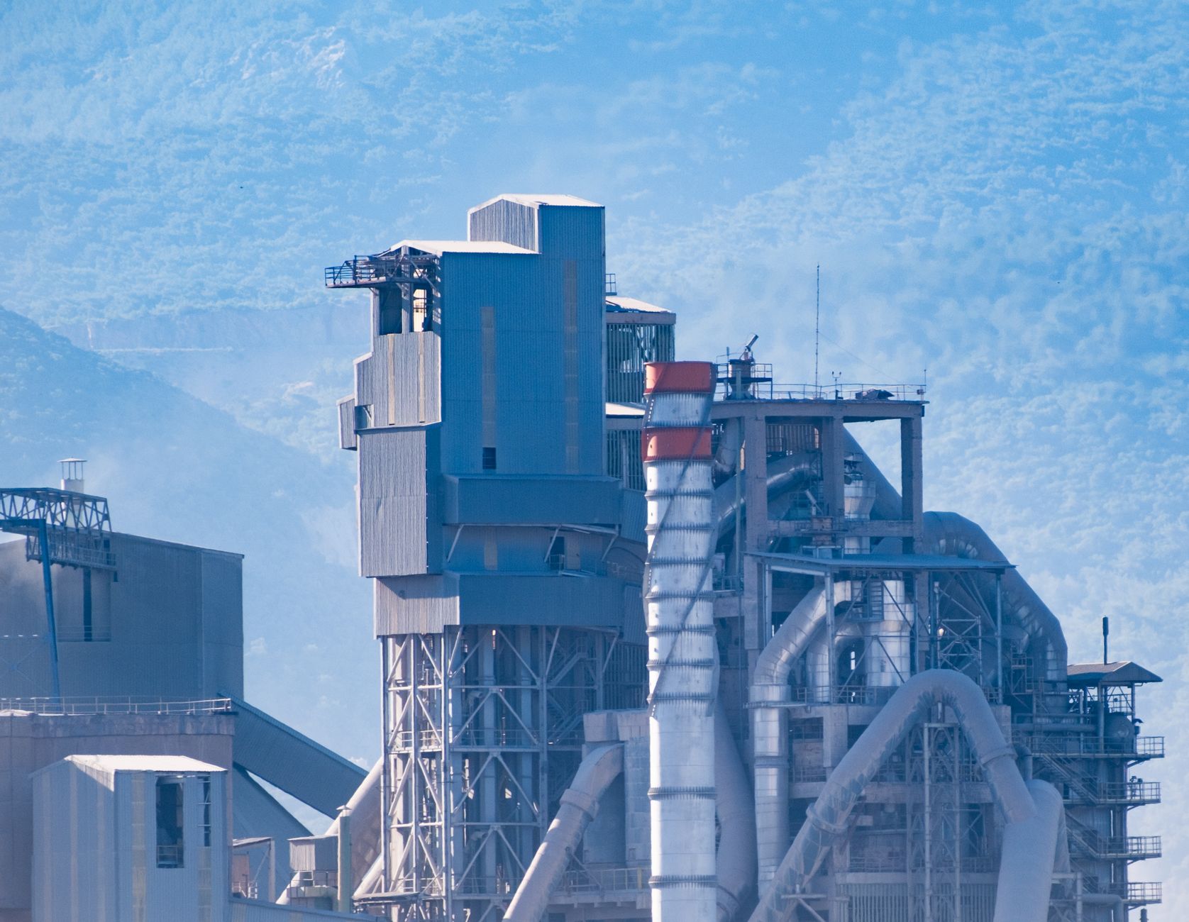 Engineer measuring emissions at an industrial smokestack