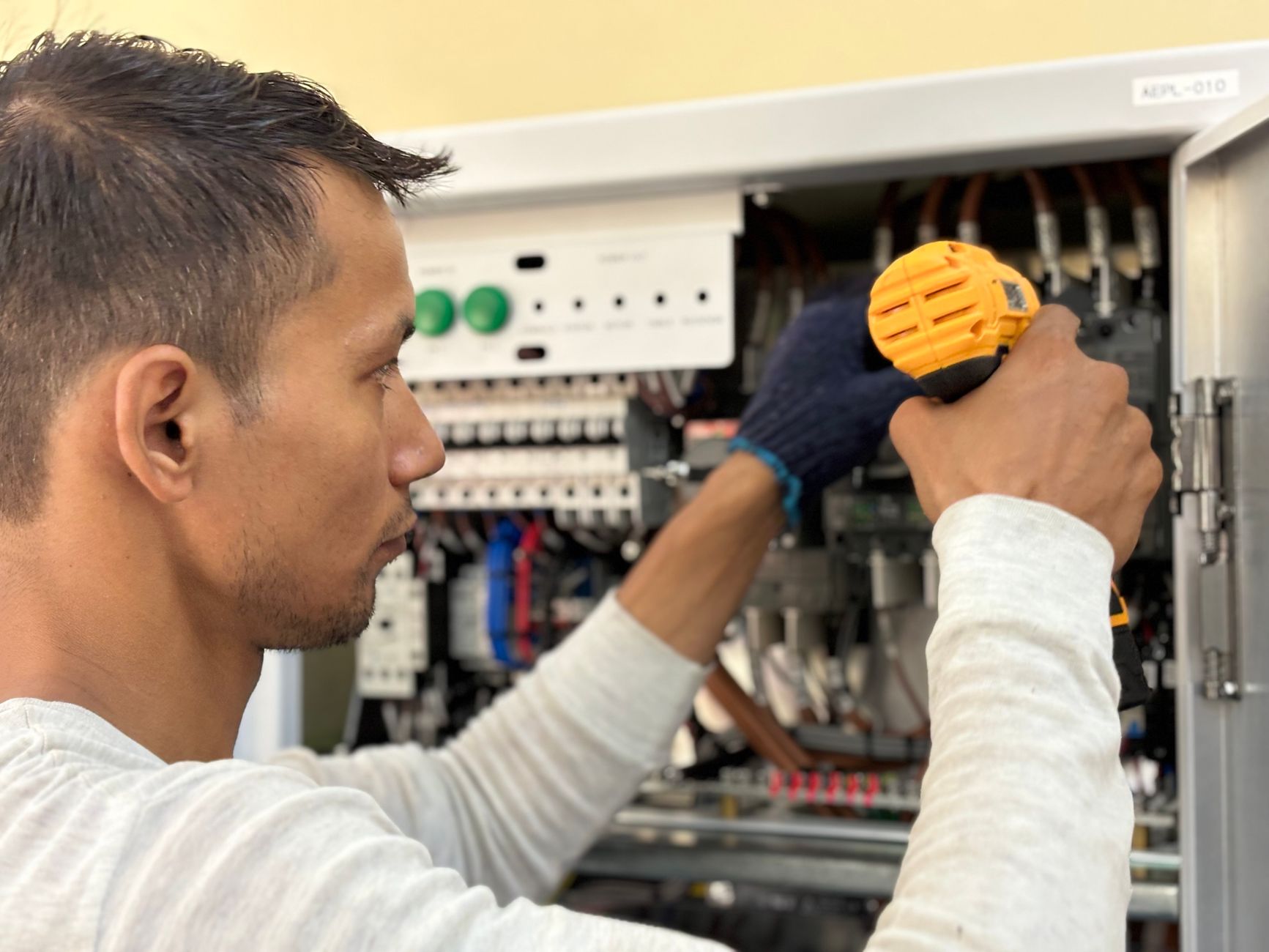 Technician troubleshooting an HMI panel
