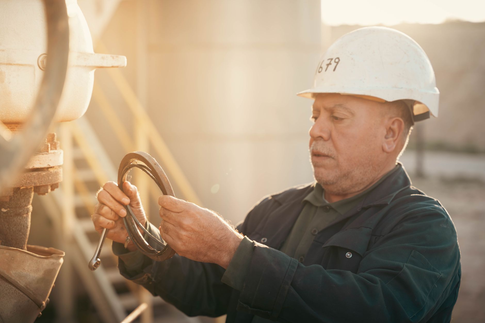 Maintenance worker repairing a hydraulic pump