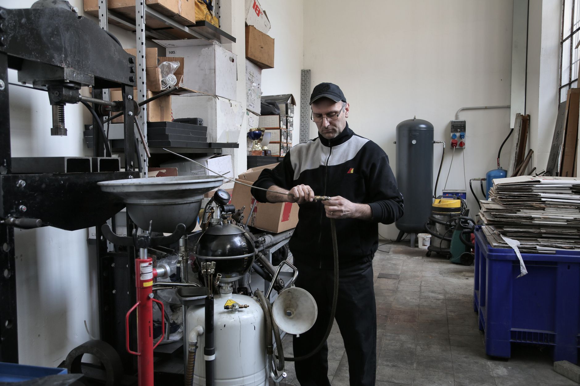 Technician inspecting a hydraulic hose fitting