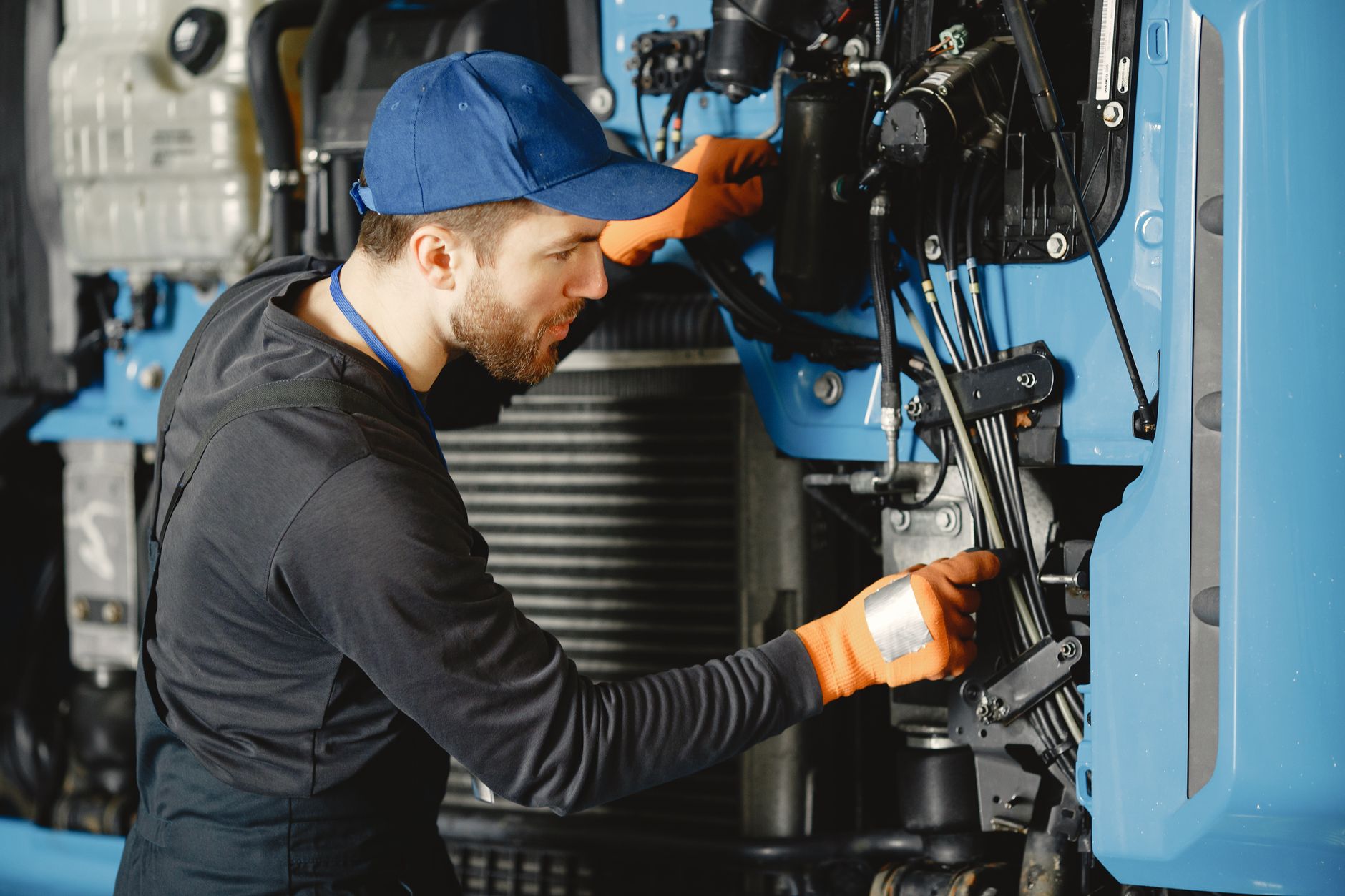 Technician repairing a hydraulic hose fitting
