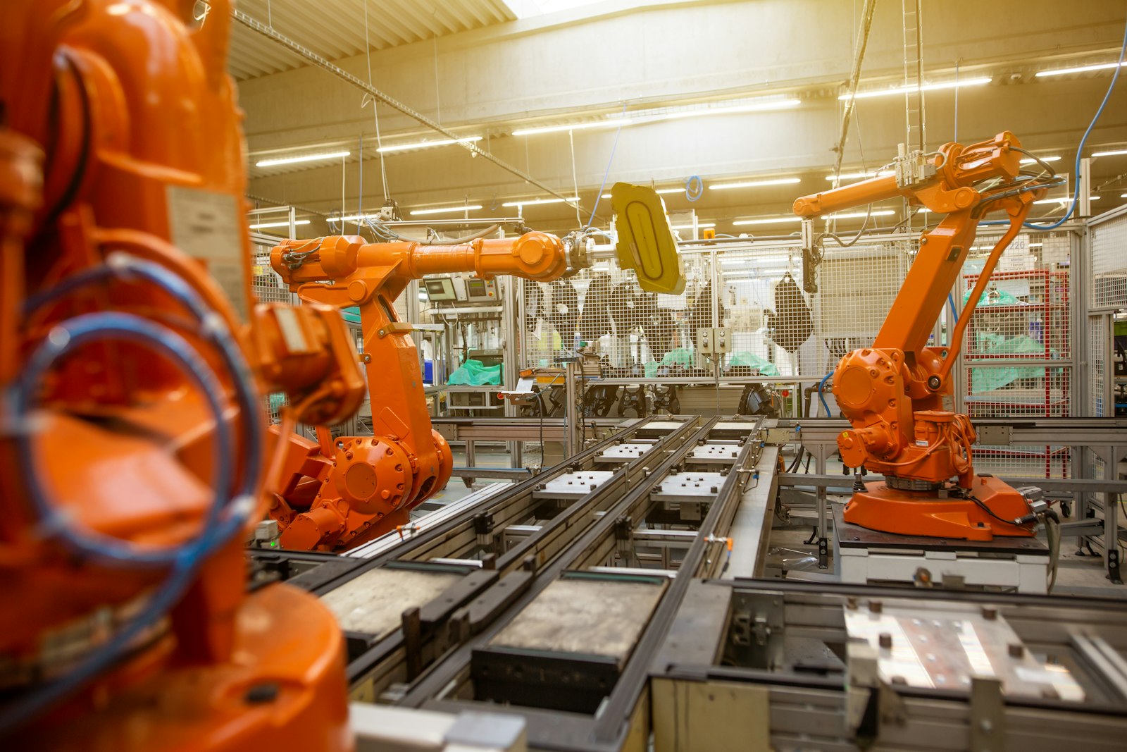 Industrial robot arms on an automated assembly line