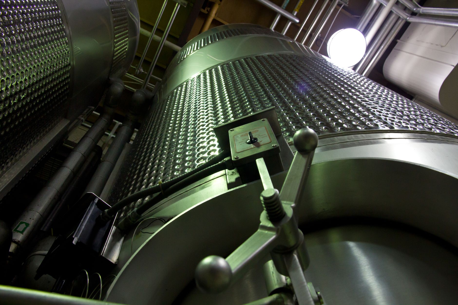 Industrial mixing tank viewed from a control room
