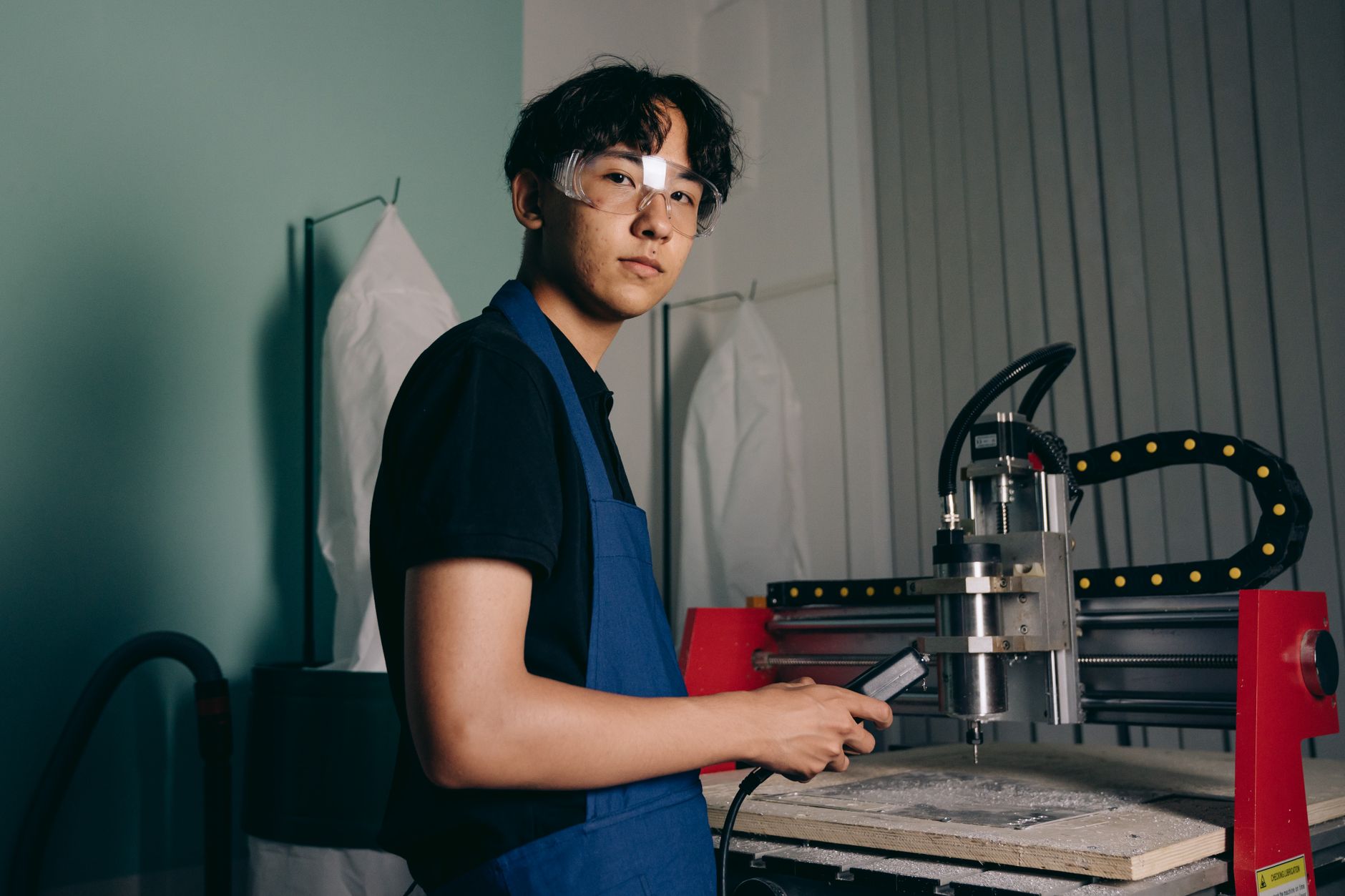 Student practicing a machining skill on shop equipment