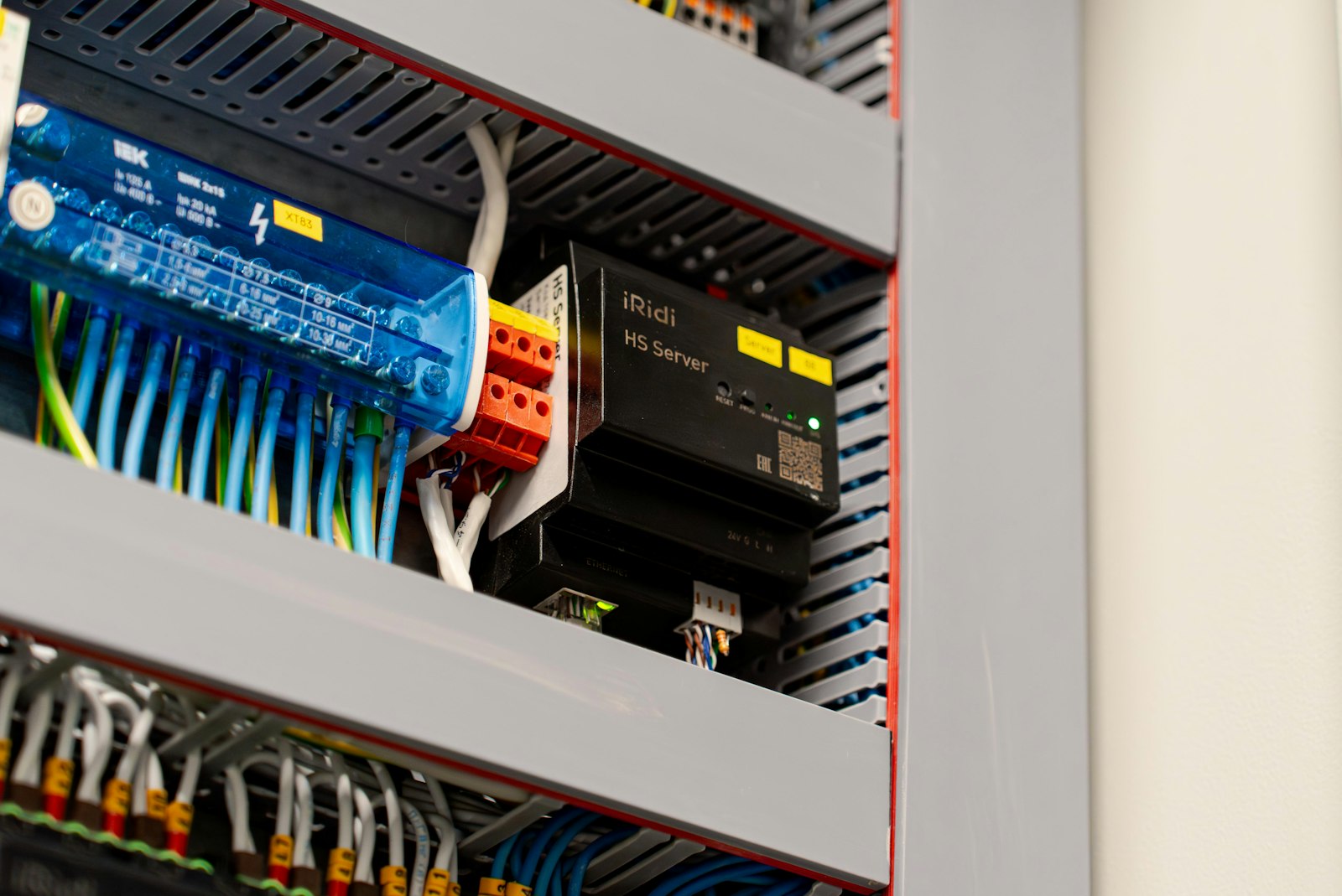 Compact industrial controller mounted inside a control cabinet with wiring