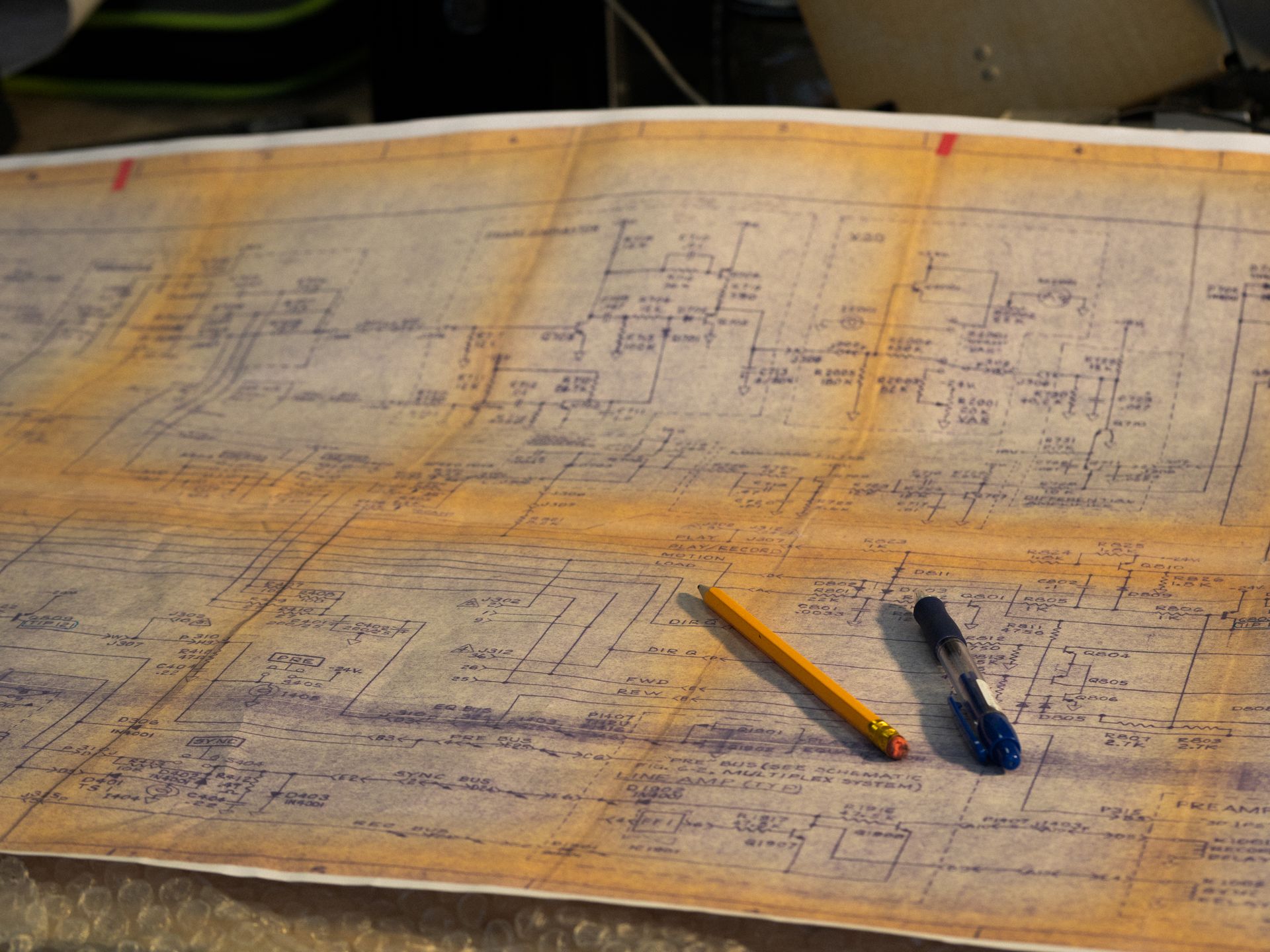 Engineering blueprint with pen and pencil on a desk