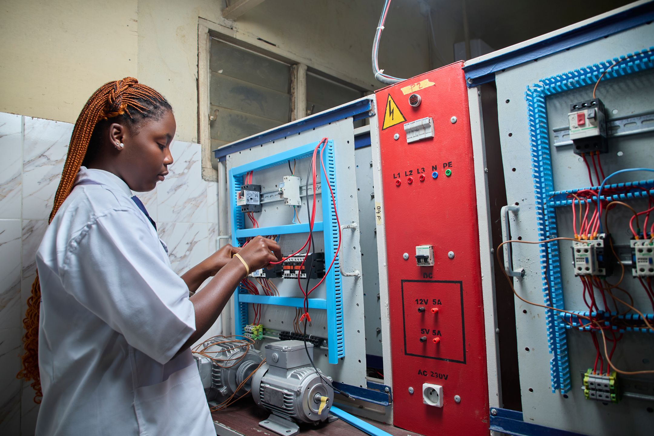 Technician inspecting an electrical control panel