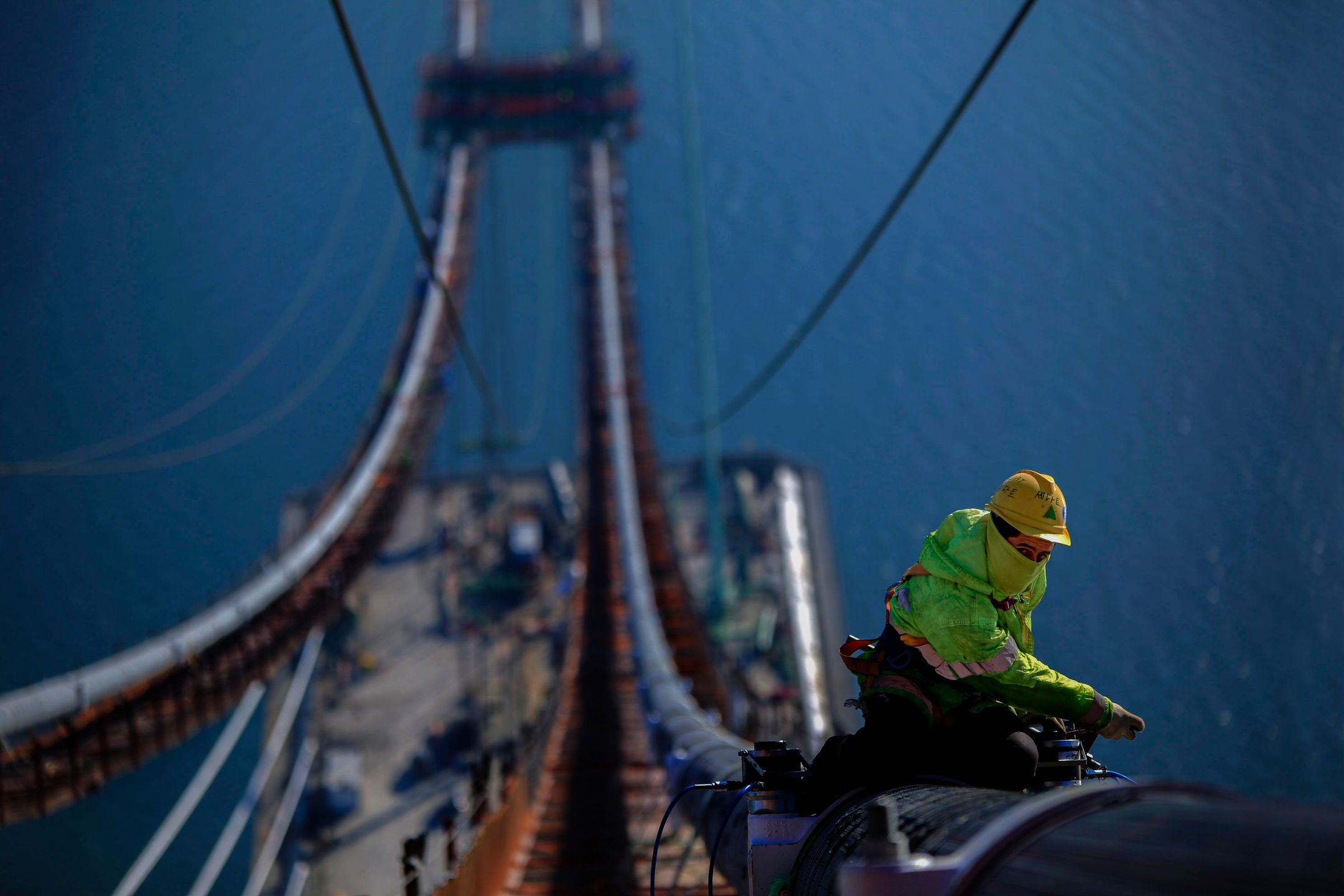 Worker inspecting rigging equipment before use
