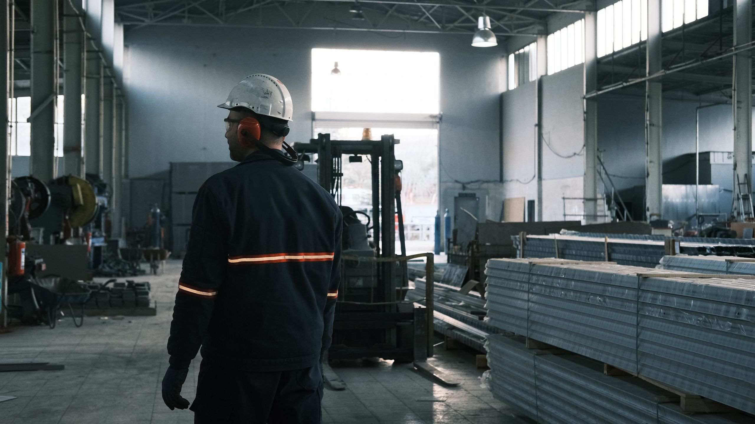 Worker walking through a manufacturing facility