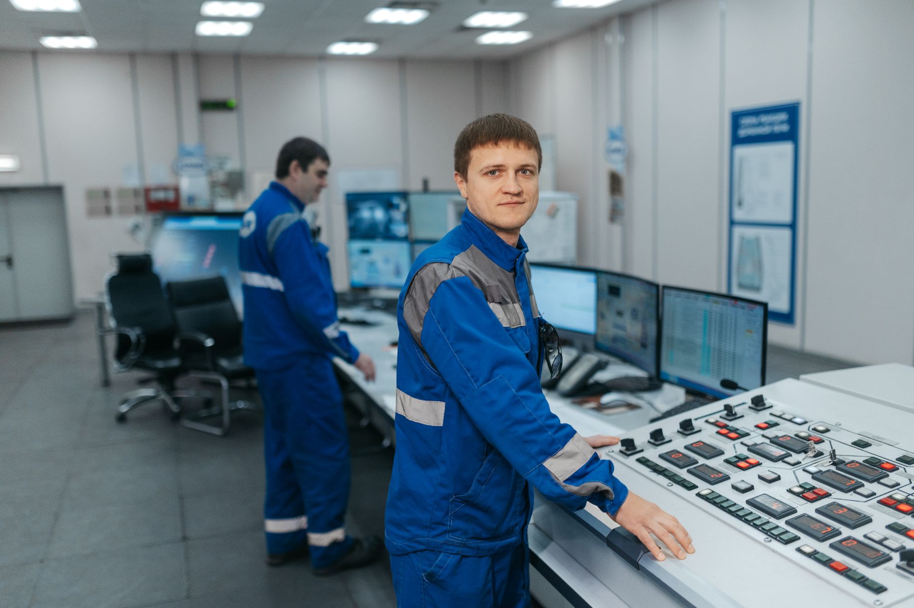 Engineer monitoring plant processes across multiple screens