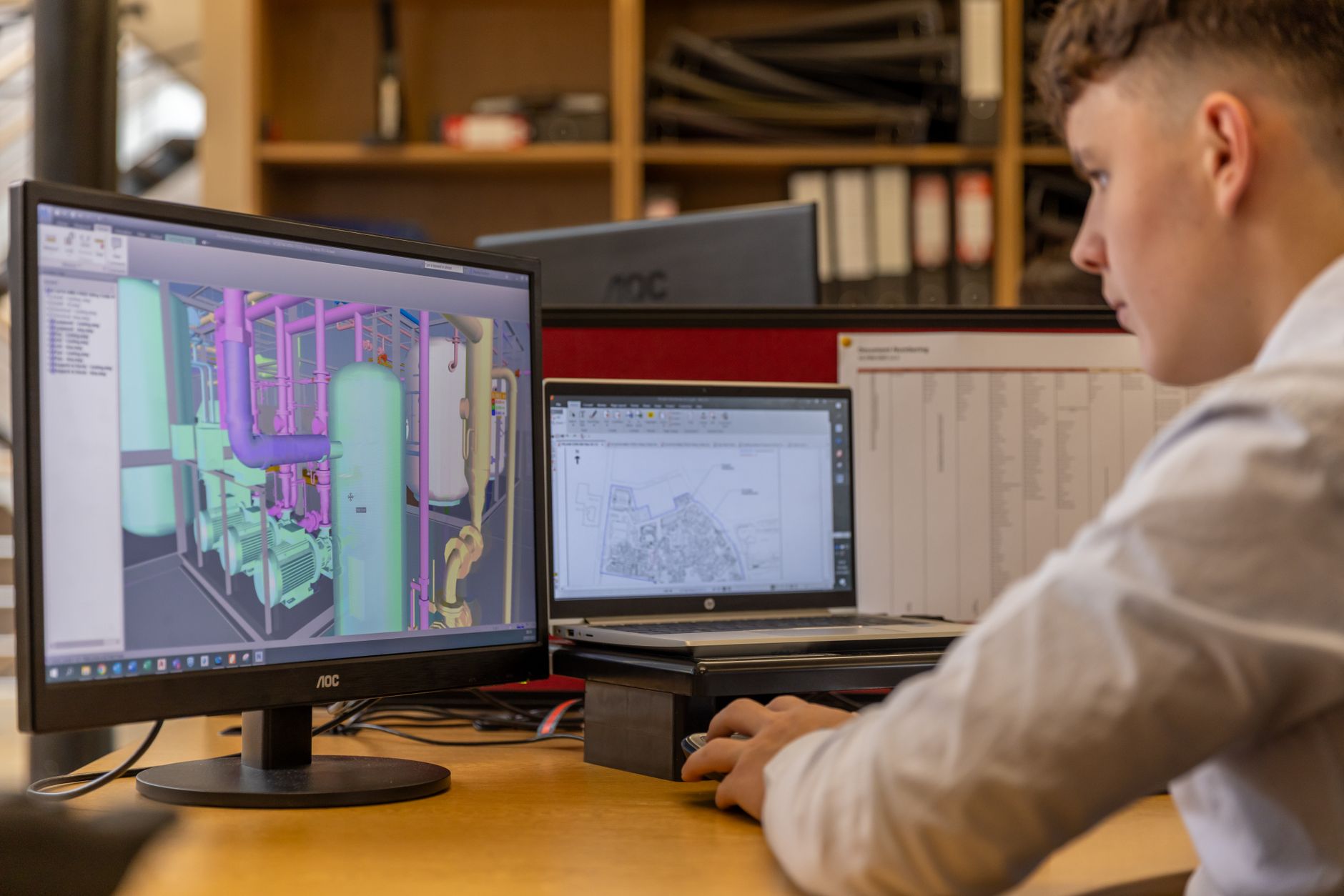 Engineer reviewing a SCADA system architecture diagram