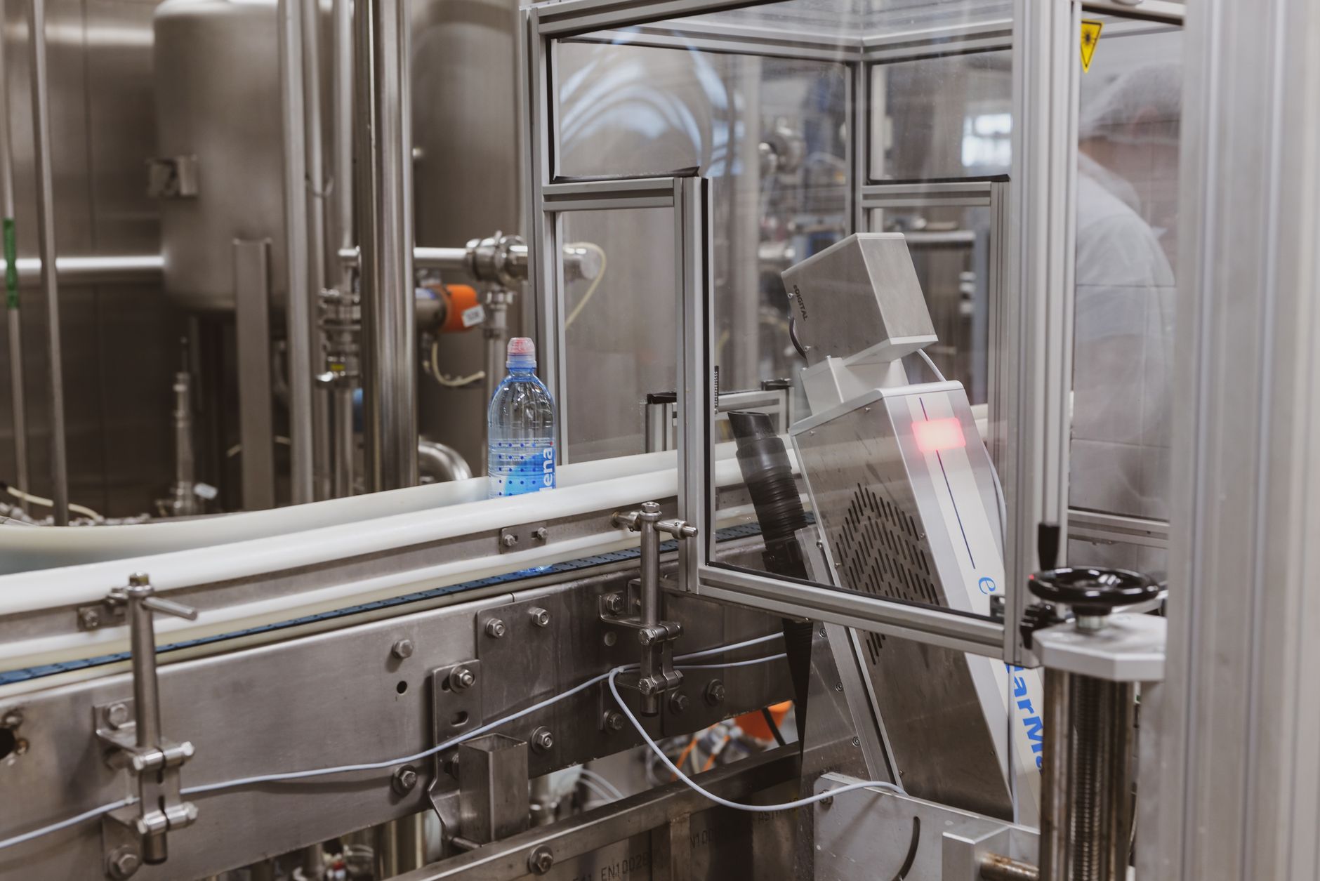 Technician installing a proximity sensor on industrial equipment