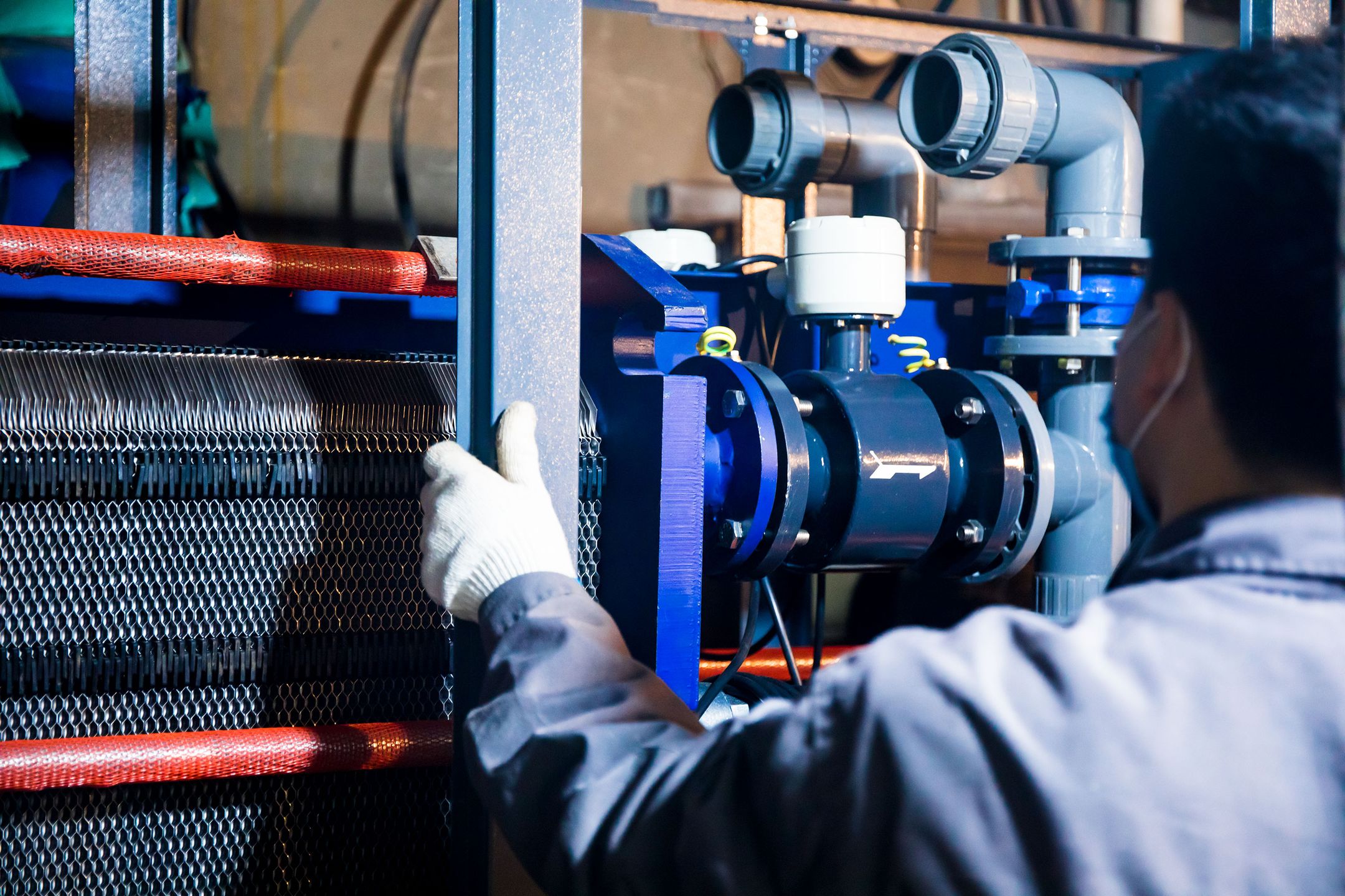 Operator cleaning and inspecting a machine as part of a maintenance routine