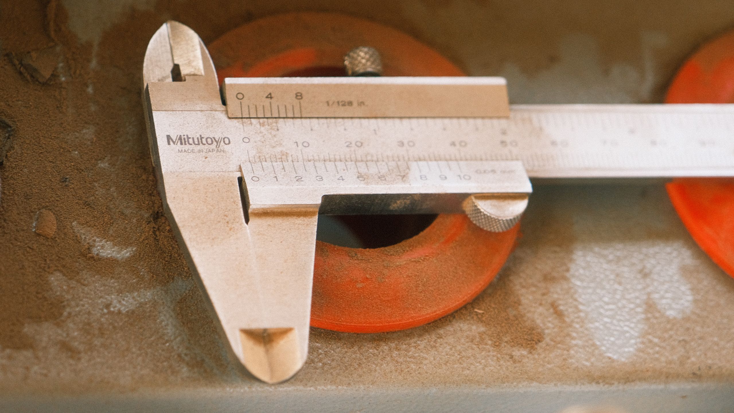 Precision vernier caliper measuring tool on an industrial surface