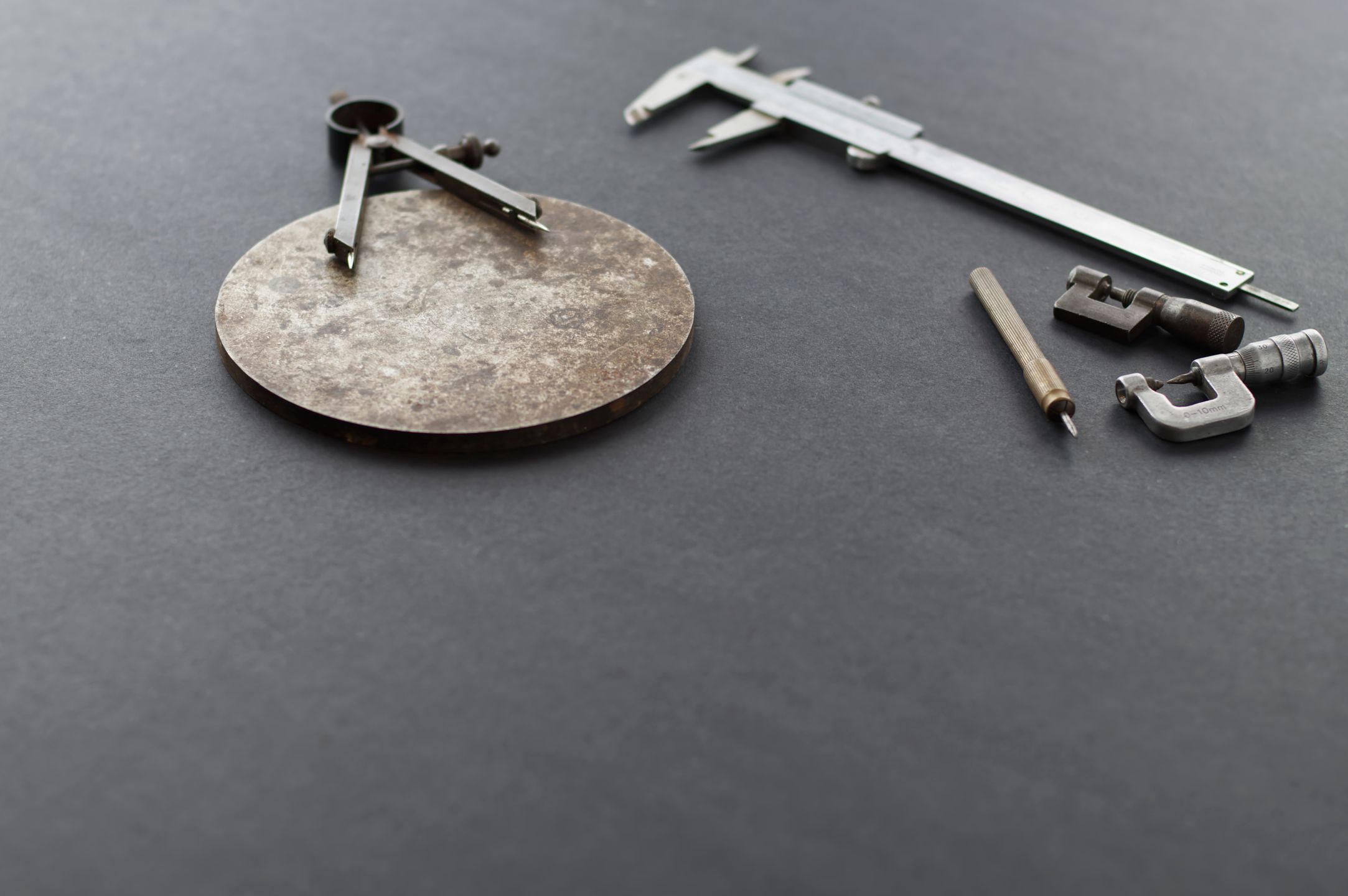 Precision measuring tools including calipers and a compass