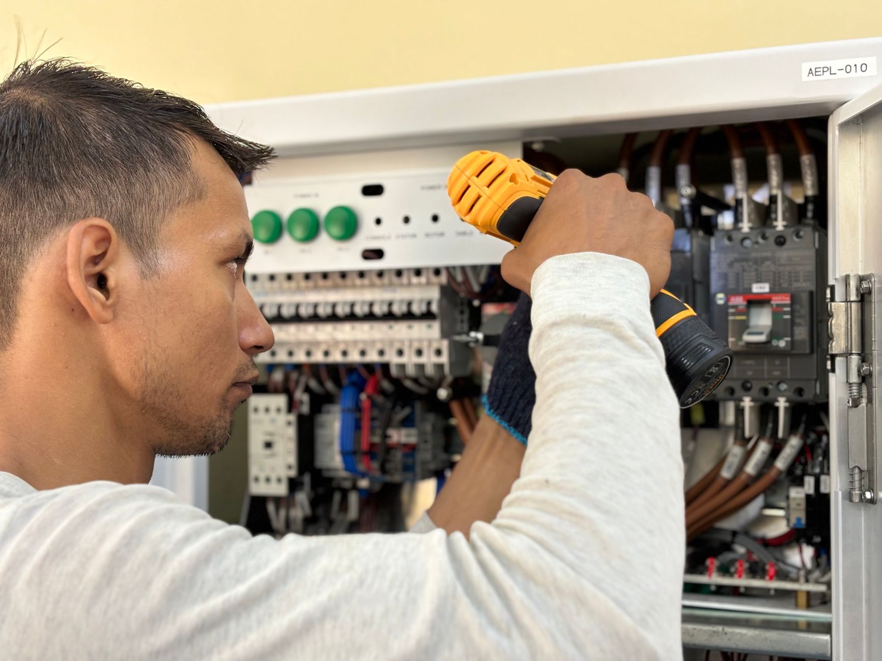 Electrician installing a variable frequency drive cabinet