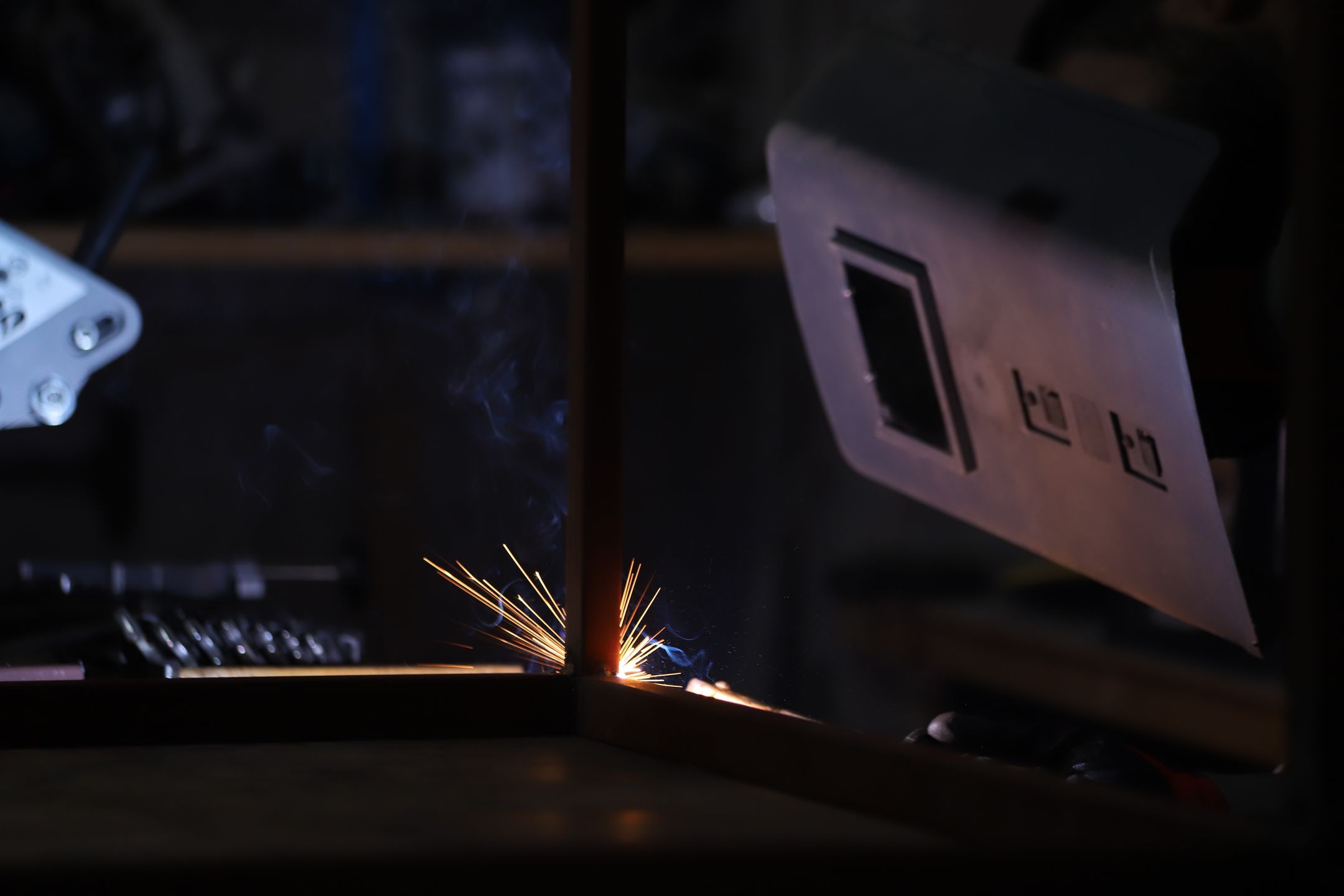 Welding process showing bright sparks in a workshop